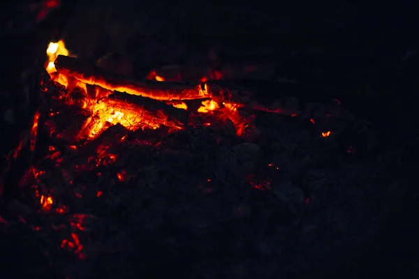 Night scene of fire sparks and flame burning with beautiful red flame.