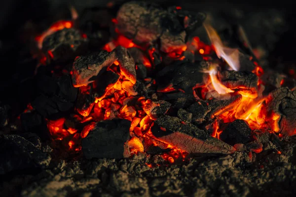 Night scene of fire sparks and flame burning with beautiful red flame.