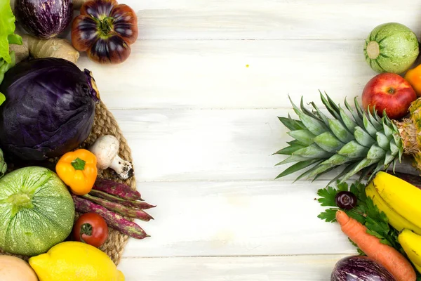 FRAME OF VEGETABLES AND FRUITS ON WHITE WOODEN BACKGROUND. COPY SPACE, HORIZONTAL HIGH ANGLE VIEW