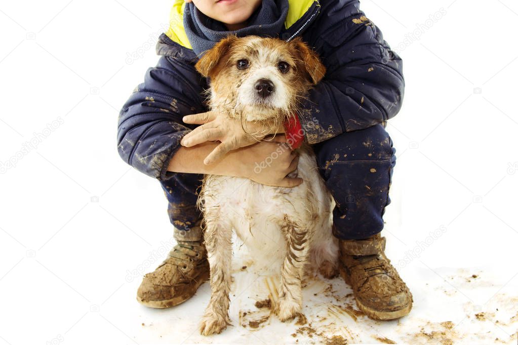 FUNNY DIRTY DOG AND CHILD. JACK RUSSELL PUPPY AND BOY WEARING BO
