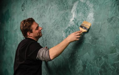 Bir duvar fırça ile boyama içinde gerçek profesyonel ressam  