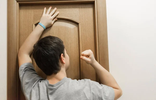 Child knocking on door before entering, home privacy concept