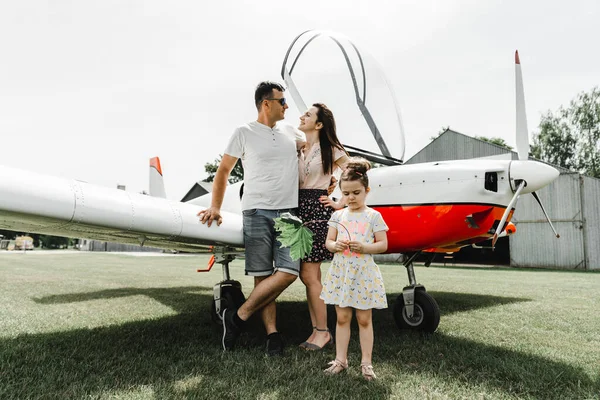 Família Feliz Divertindo Grama Verde Perto Avião Belo Casal Com — Fotografia de Stock