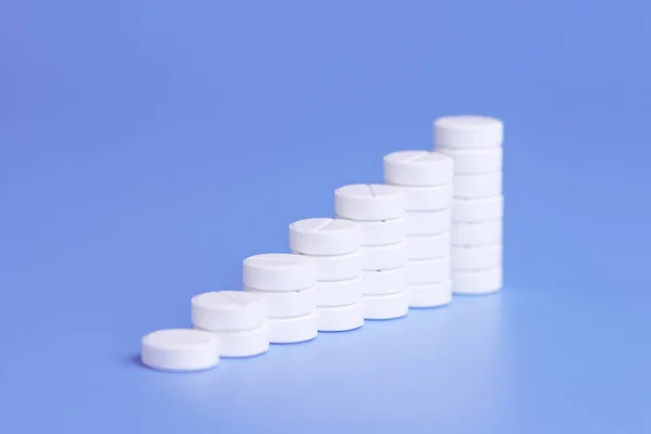 White pills or tablets stacked on each other in the form of step