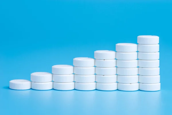 White pills or tablets stacked on each other in the form of step