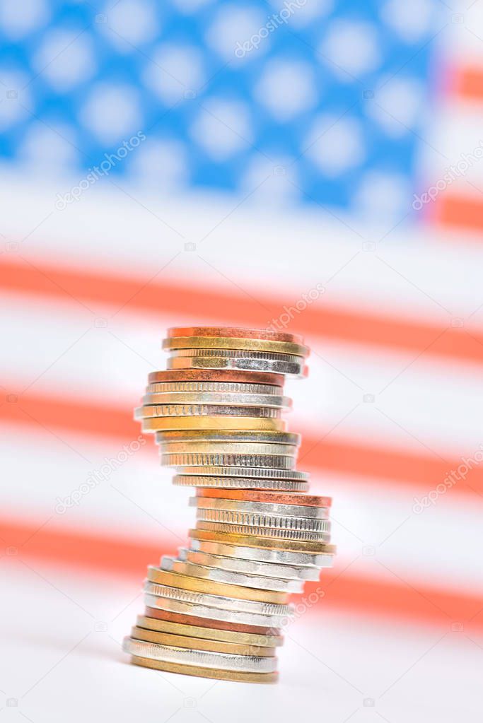 Coins stacked on each other in different positions on red and wh