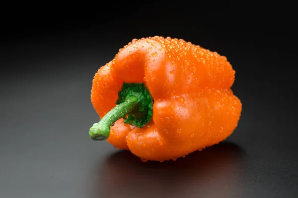 Fresh bright colorful peppers on a black background — Stock Photo, Image