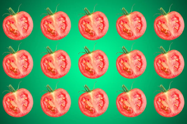 Vegetable pattern of red tomatoes sliced green background.