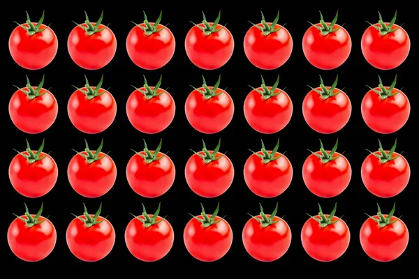 Siyah arkaplanda kırmızı domateslerin sebze deseni. — Stok fotoğraf