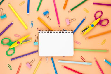 Pembe pastel arka plan üzerine turuncu kalemler. 