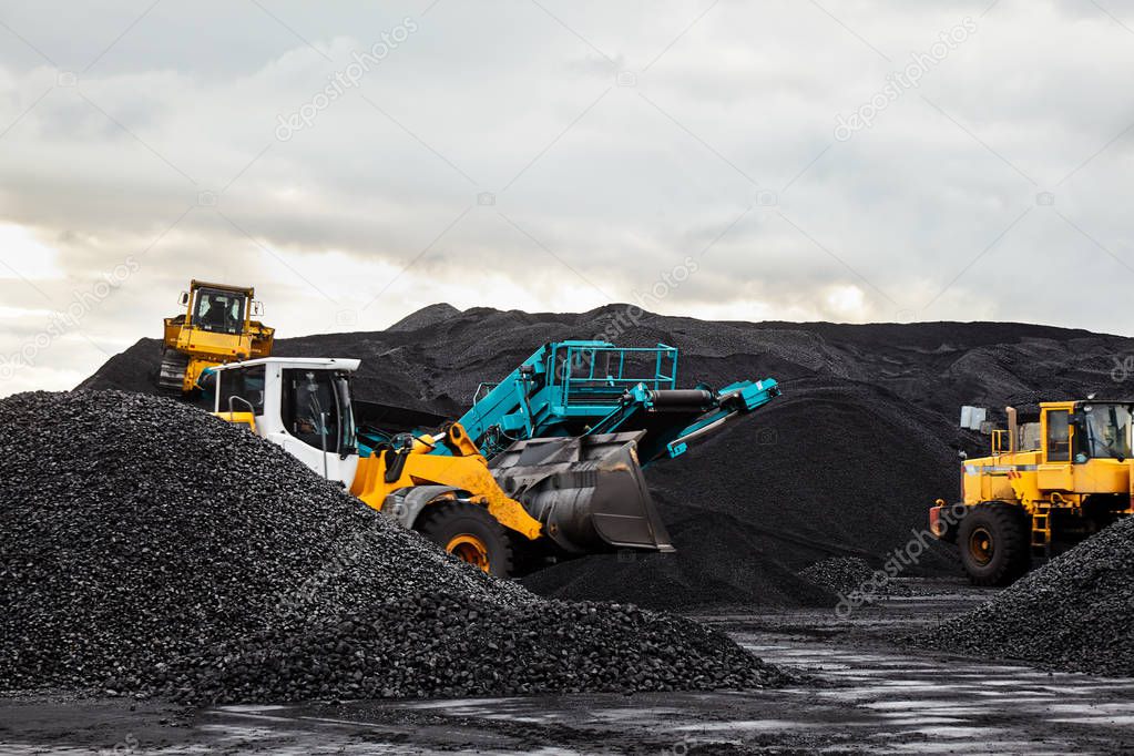 Caterpillar tractors collect black coal pile. Illustration of supply field of power station.