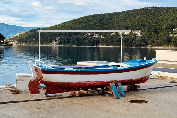 A classic Mediterranean fishing boat undergoing renovation in th