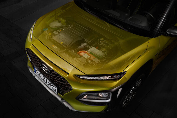 Katowice / Poland - 02/16/2020: Hyundai Kona hybrid engine. Electronic assembly of engine photos and closed engine bonnet. The total power of the gasoline and electric engine is 141 hp.