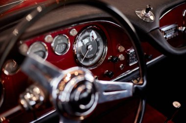 Katowice/Poland - 06.08.2019: Steering wheel and dashboard of the historic Maserati 3500 GT. Manufactured between 1957 and 1964. 270 hp R6 engine. Maximum speed is 235 km/h. clipart