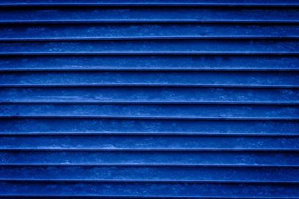 retro-styled blue fashioned shutters or blinds, worn down with scissors, there is free space for text