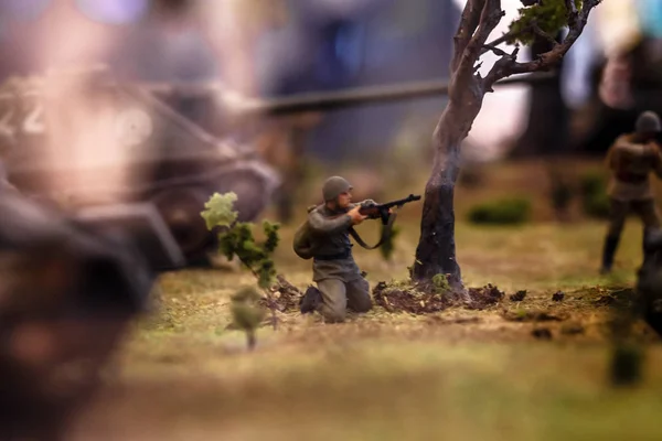 Conceptual photo showing a toy war among toy plastic soldiers with decorations