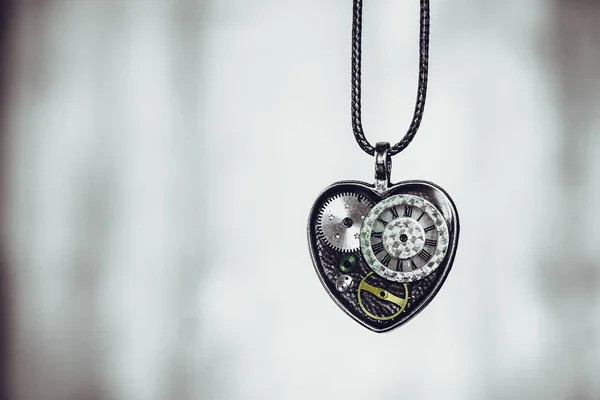 jewelry in the form of a heart, and inside it a dial from the watch; may mean that there is always time for love, it's never too late to love, etc.