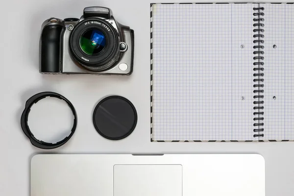 Travel gadgets flat lay on white background