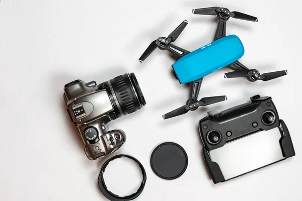 Travel gadgets flat lay on white background