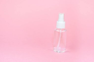 Güzellik kozmetik cam şişesi; markalama alay; pastel pembe arka plan ön görünüm. Uçucu yağ için paket.