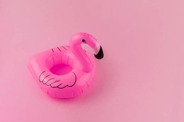 Pastel pembe arka plan üzerinde izole şişme pembe flamingo. Yaz afiş konsepti