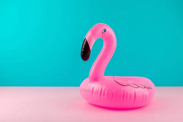 Opblaasbare roze flamingo op pastel blauw en roze achtergrond. Pool float partij, trendy zomer concept. Platte lay, kopieer ruimte. — Stockfoto