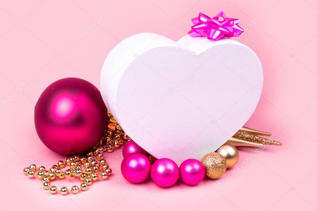 Pink christmas balls, gold Christmas decorations, Gift box on pink background. Christmas gifts and decoration on pink background with copy space for text. 