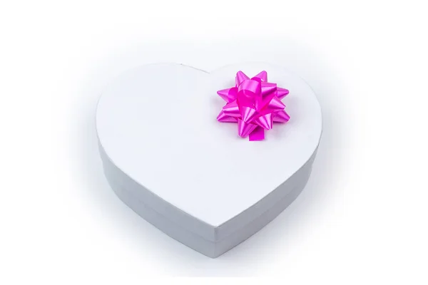 Białe serce w kształcie pudełka z różowym łuku na wakacje, Boże Narodzenie, dzięki dając dzień, urodziny widok z góry na białym tle. — Zdjęcie stockowe
