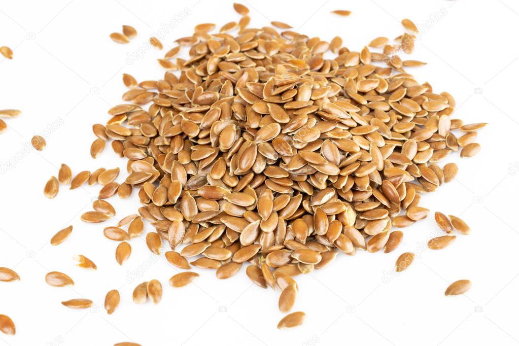 Some linseeds, Flax seeds, spread out on white background. Diet and healthy eating concept.