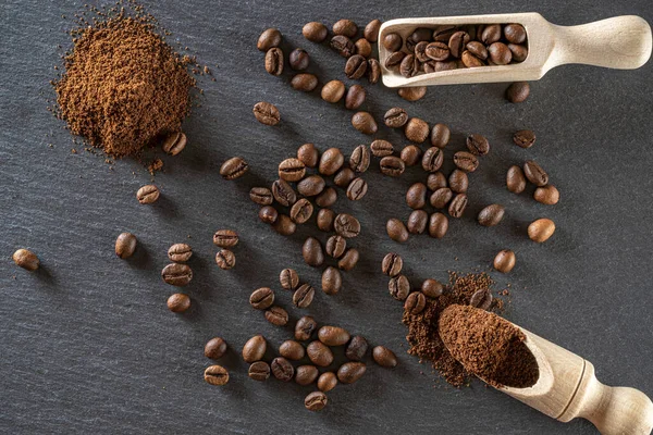 Cafe coffee background. Espresso beans for food, drink caffeine breakfast on black. Brown roasted coffee seeds isolated for energy mocha, cappuccino ingredient. Copy space, top view.