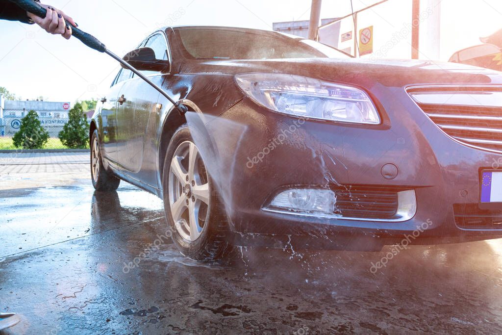 Service clean car. Carwash with water, soap. Hand vehicle auto from foam. Care with pressure wax.