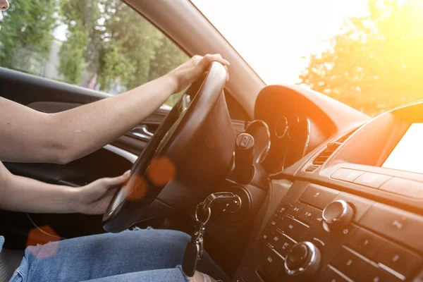 Travel car trip on road at sunset. Happy young woman have fun driving inside vehicle in summer sunny day. Driver ride vacation concept