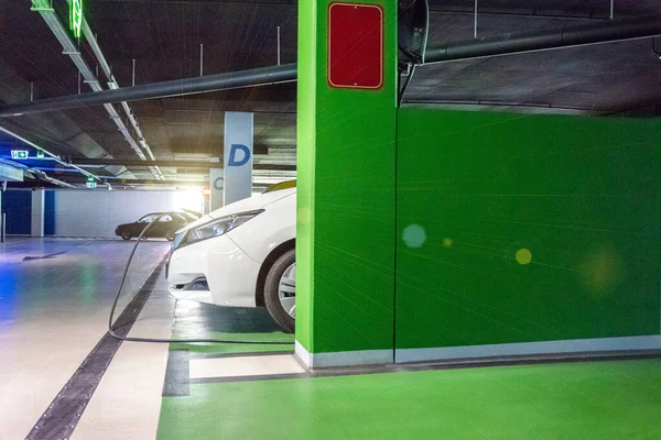 Eco auto. Electric car charge battery on eco energy charger station. Hybrid vehicle - green technology of future. Clean energy future of transportation ecology concept