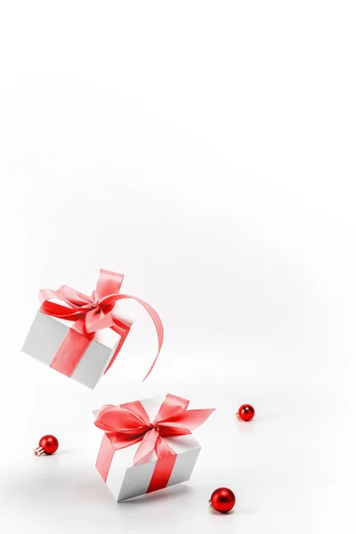 冬の背景赤 赤いリボンの白いギフトボックス グリーティングカードのための白い背景にクリスマスの組成物の新年のボール クリスマス 新年のコンセプト — ストック写真
