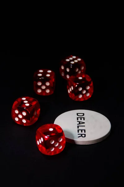 Descripcin: Game of dice on black background with dealer tab. Game of red dice on black background. Five red dice on black carpet and dealer card.