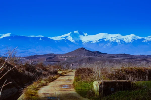 San Lorenzo karlı dağ Ezacaray, La Rioja içinde. Üzüm bağları ve yol.