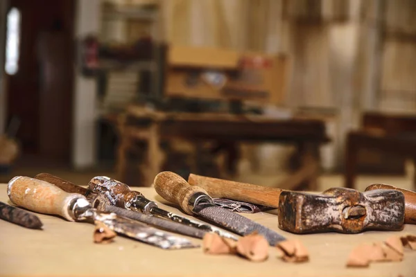 Carpenter tools. Chisel or gouge for wood on carpenter working at workbench. Carpentry workshop Royalty Free Stock Images