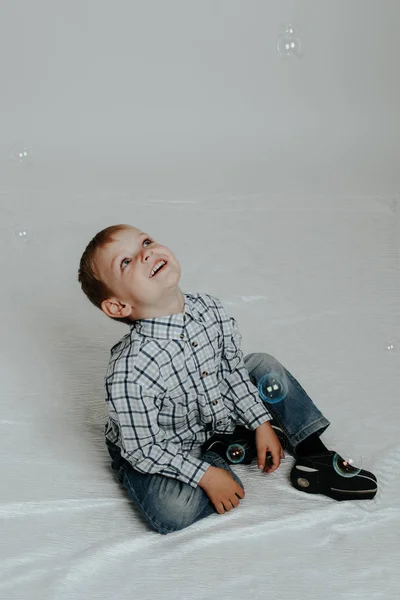 Little boy playing with soap bubbles — Stock Photo, Image