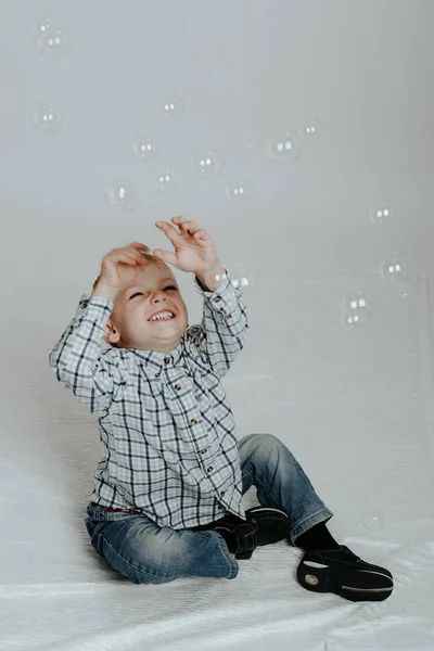Маленький хлопчик грає з мильними бульбашками — стокове фото