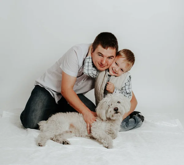 Family father and boy sit with dog
