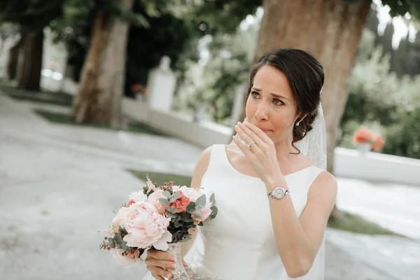 Beautiful gorgeous brunet bride crying at the wedding day.