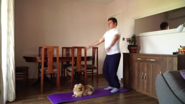 Gerçek Insanlar Yapımı Görüntüler Şişman Adam Pomeranya Köpeği Evde Jimnastik — Stok video