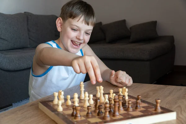 Playing board games. The child playing chess.