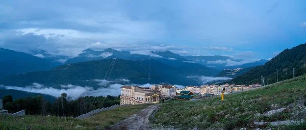 Evening panoramic view of the hotel complex in the mountains covered with green forests