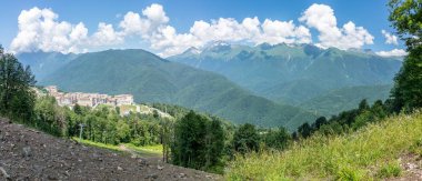 Otel kompleksi teleferik dağlarla çevrili bir yeşil vadi