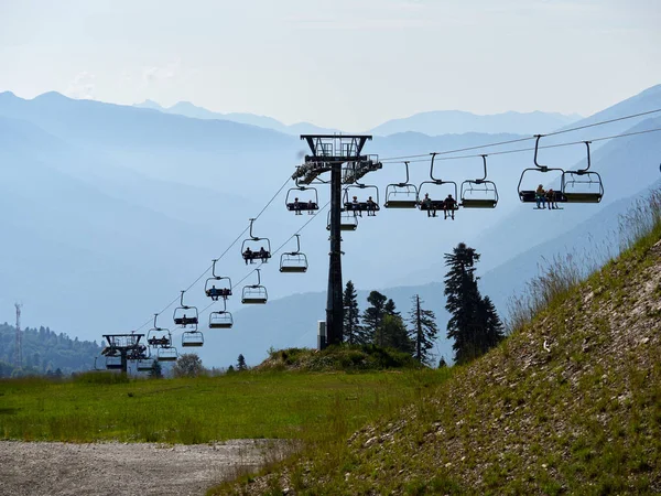 Cable car on the ski slope in a cloudy summer day. Stock Image
