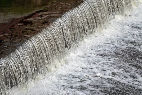 A small flat cascade in a calm river