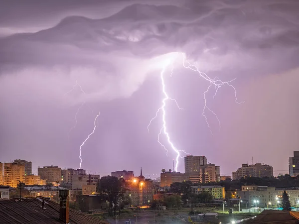 Photo of beautiful powerful lightning over big city, zipper and thunderstorm, abstract background, dark blue sky with bright electrical flash, thunder and thunderbolt, bad weather concept