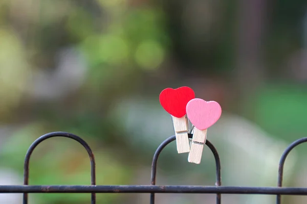 Love Concept Two Clips Heart Shape Fence Green Background — Stock Photo, Image