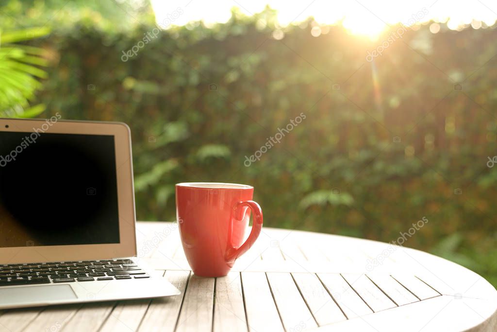 Work concept: Laptop and red mug